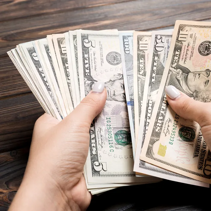 a lady holding foreign currency dollar