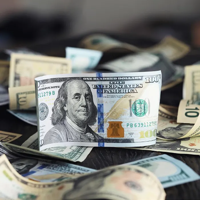 a stack of curency dollar on a table