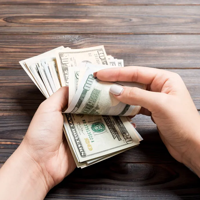 a lady holding foreign currency