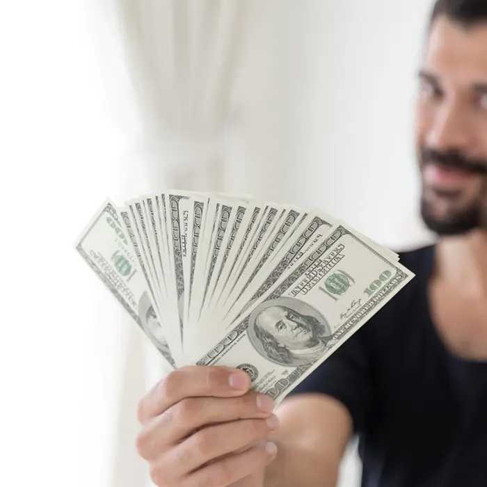 a man holding foreign currency dollar