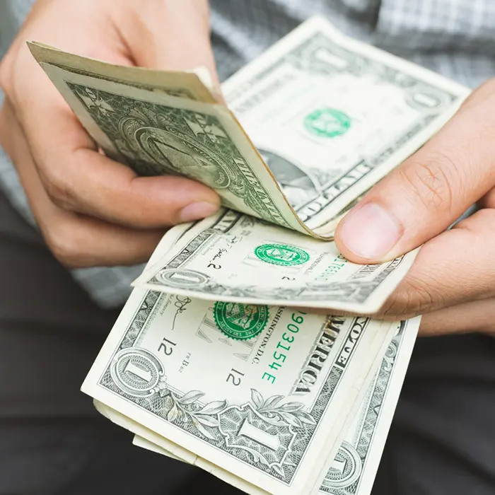 a man counting foreign currency dollar