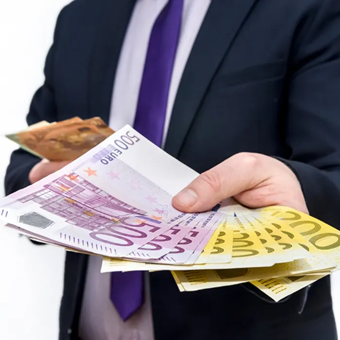 a man in suit offering foreign currency euro