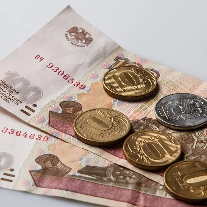 foreign currencies and coin on a white background
