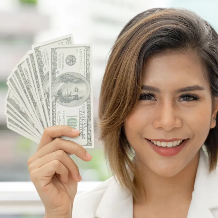 a lady holding dollar