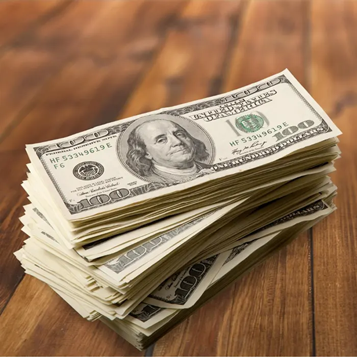 a stack of foreign currency dollars on a table